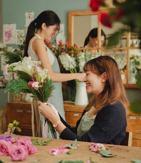 Focused florist arranging flowers in floral shop